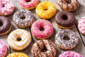 close up of donuts showing glossy glaze, crunchy toppings, and soft interior texture